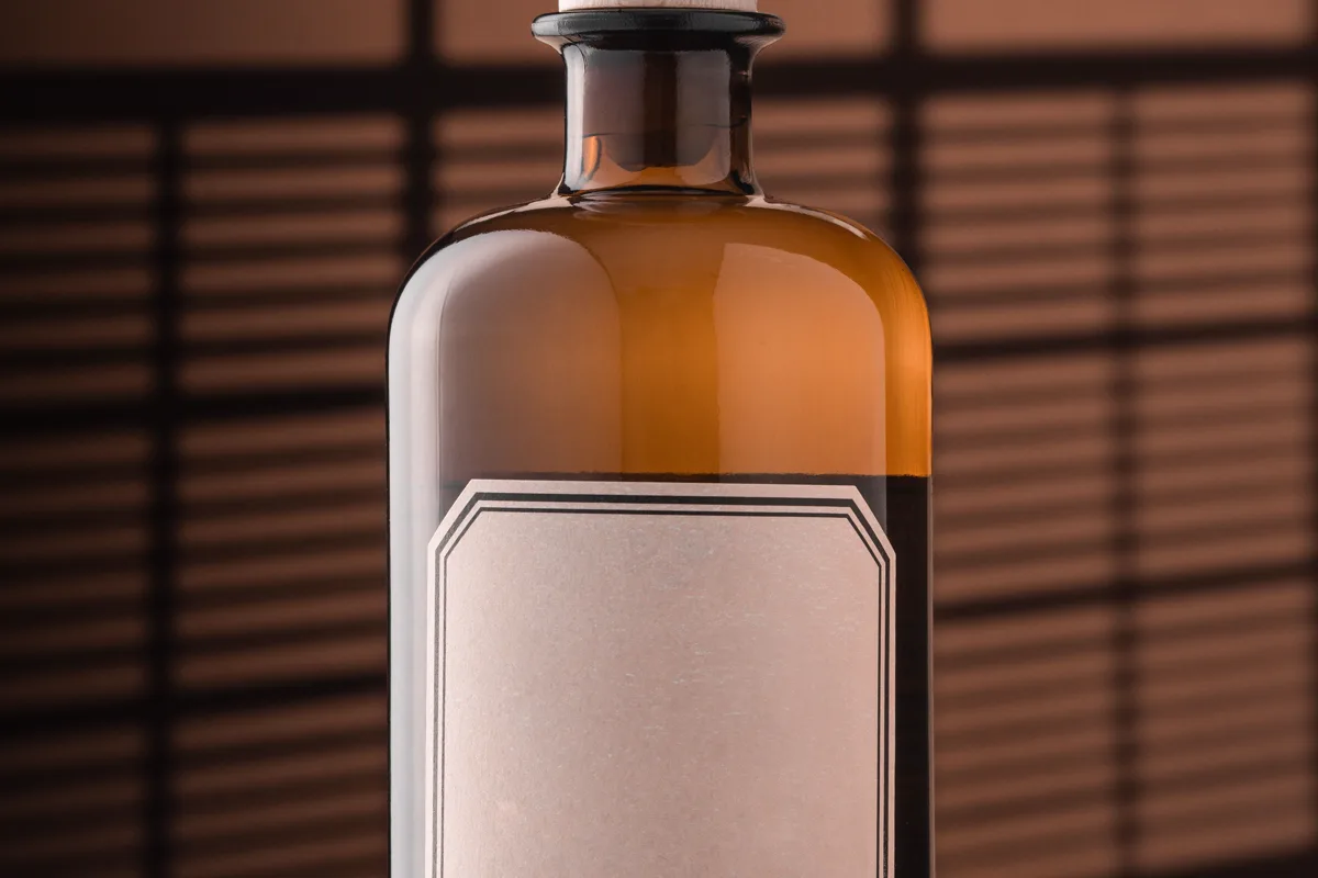 Amber glass bottle with a blank label