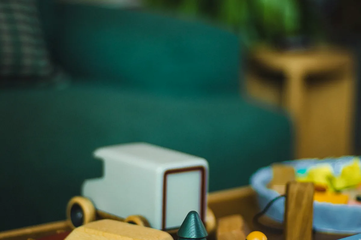Wooden toys and books arranged on a coffee table