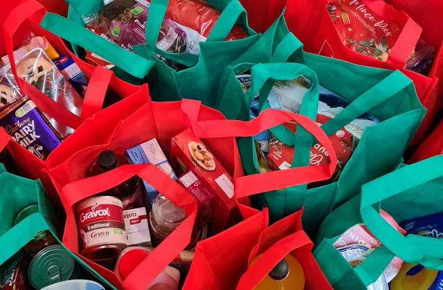 Reusable shopping bags filled with packaged groceries